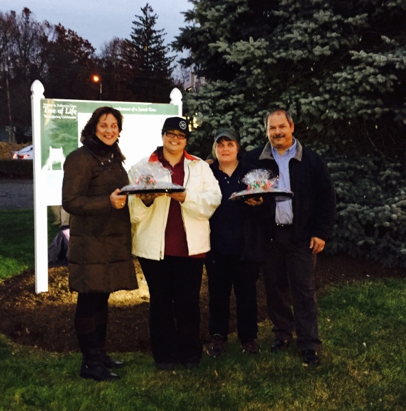 (L to R) Janet Gallugi of the VNA stands with Between Rounds Bakery Sandwich Café's Michelle Harding, Assistant Manager, Kim Sears, Manager, and Jerry Puiia, co-owner during the "The Tree of Life" memorial Tree Lighting ceremony.