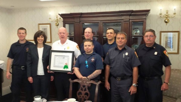 Marlene Rotering, President and CEO of Edgewood LifeCare Community presents a Certificate of Appreciation to Chief Andy Melnikas and staff to hang in the new North Andover Fire House Headquarters. 