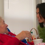 State Representative Keiko Orrall delivers a meal to Elin Young