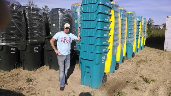 Matt Romboldi, owner of Lombard's Waste Service, with the teal recycle bins touting ovarian cancer awareness