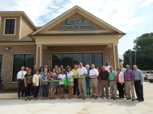 John and Billye Jean Stroud, center, pose with the staff of the brand new Lapels Dry Cleaning of New Albany, MS. The new store and plant represents the first Lapels franchise in Mississippi. 