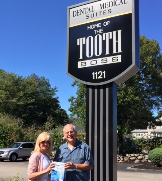 Celtic Angels Owner Maria Burke, left, receives the Smiling Neighbor award from Dr. Richard Wolfert, DMD. 