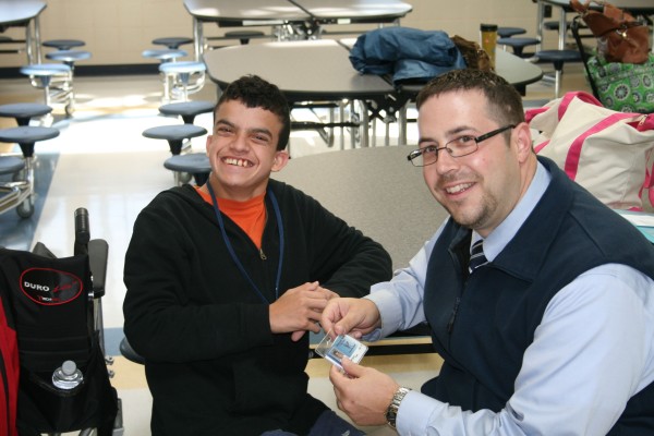 Tracy Chevrolet Cadillac General Sales Manager Joe Wilkerson with one of the Best Buddies recently honored at Plymouth North High School. More than 50 high school students participate in the Best Buddies program. 