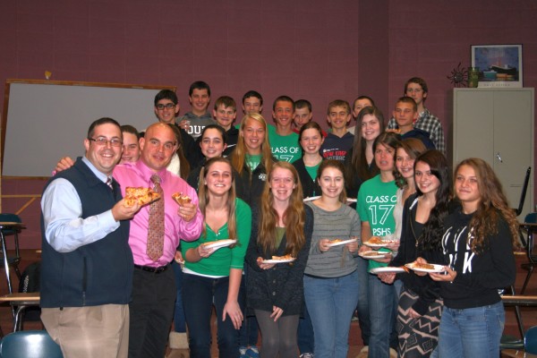 Tracy Chevrolet Cadillac General Sales Manager Joe Wilkerson (far left) and Plymouth South Vice Principal Marc Loranger toast Plymouth South students have not only achieved perfect attendance so far this year but have also made the honor roll. 